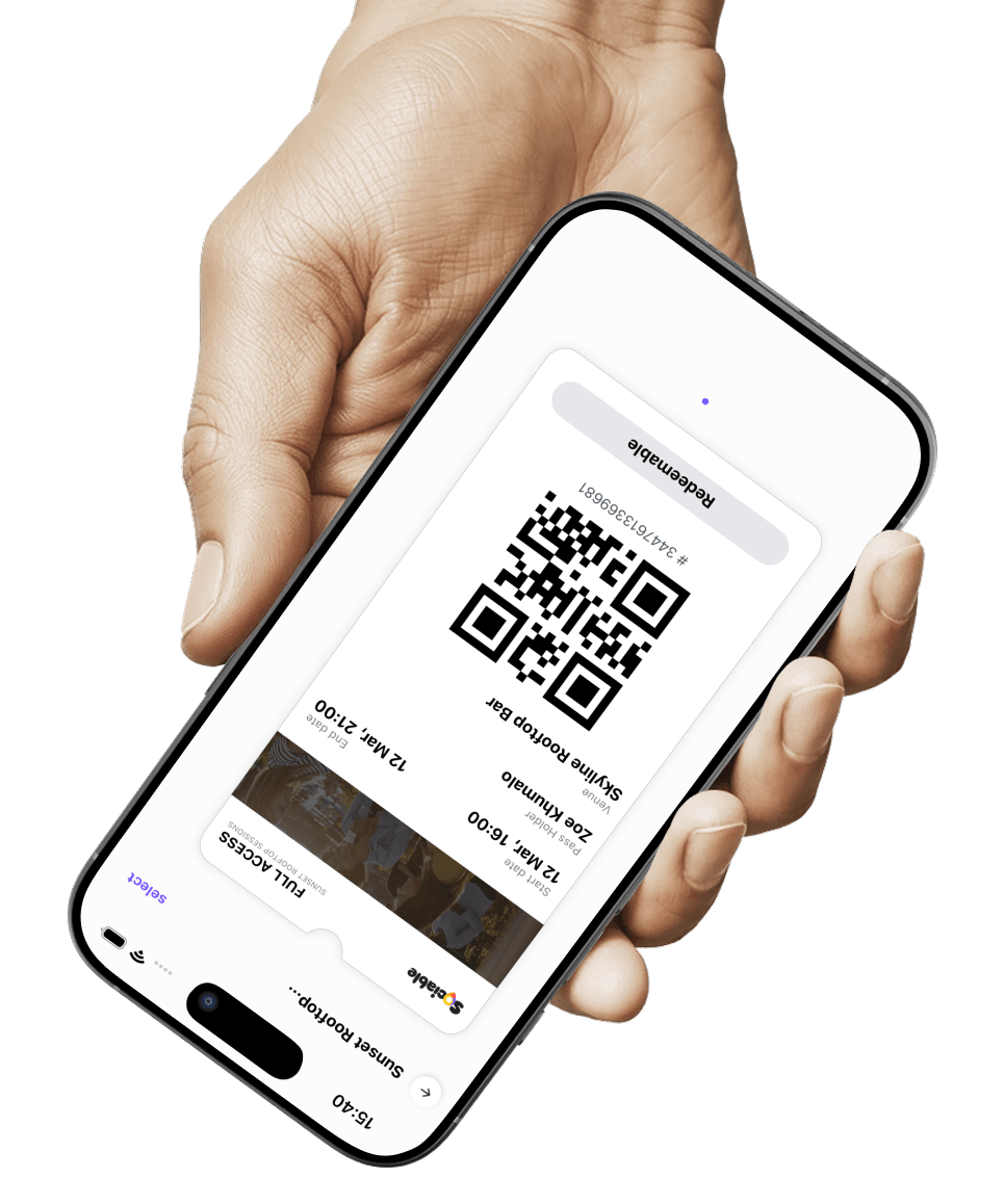 A hand holding a phone showing an event pass with QR code in the Sociable app